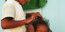 Niña peinando a su hermana, favela de Sao Paulo, Brasil